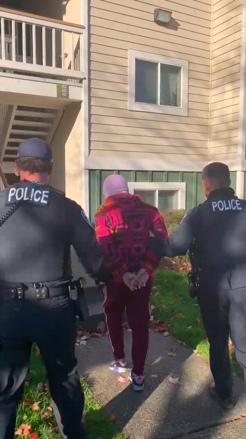 Olympia police officers escorted Isaac Hawkes-Engberts back into his apartment on Nov. 16, 2021 so they could collect the handgun they say he brandished.